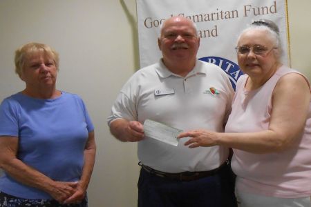 Ann Farr and Susan Edgerton, of the King Point Krafter's Club, present a check to Kirk Warren, Office Manager